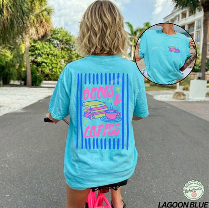 Person wearing a light blue t-shirt with 'Books & Coffee' design, riding a pink scooter outdoors.