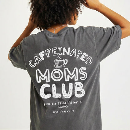 Person wearing a gray t-shirt with 'Caffeinated Moms Club' text on the back