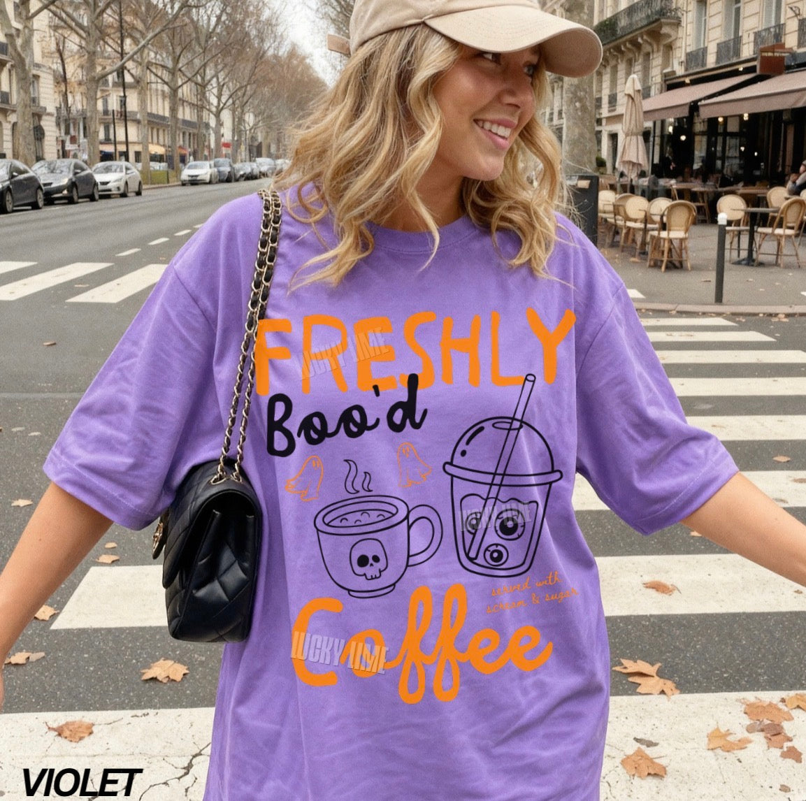 Woman wearing a purple t-shirt with coffee-themed text on a city street.