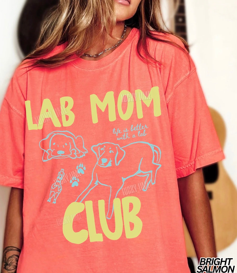 Person wearing a coral t-shirt with 'Lab Mom Club' text and graphics.