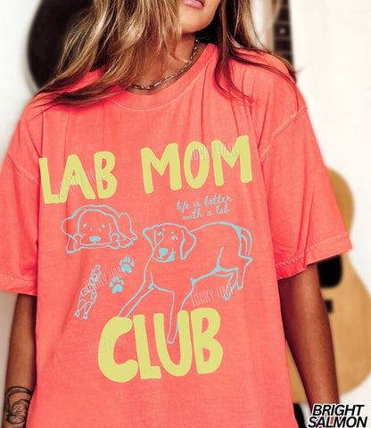 Person wearing a coral t-shirt with 'Lab Mom Club' text and graphics.