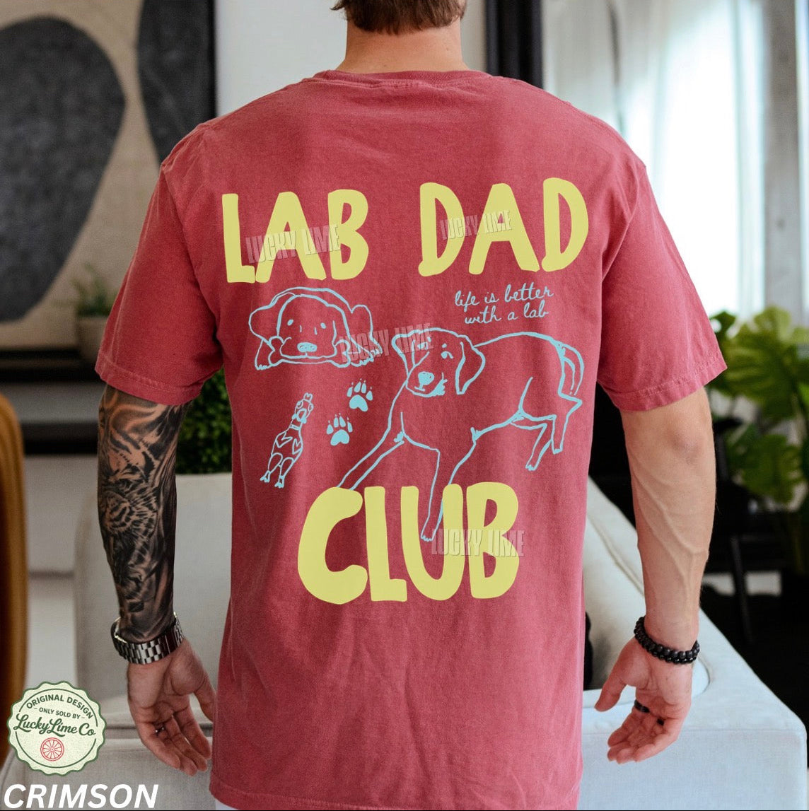 Red t-shirt with 'Lab Dad Club' text and graphics worn by a person indoors.