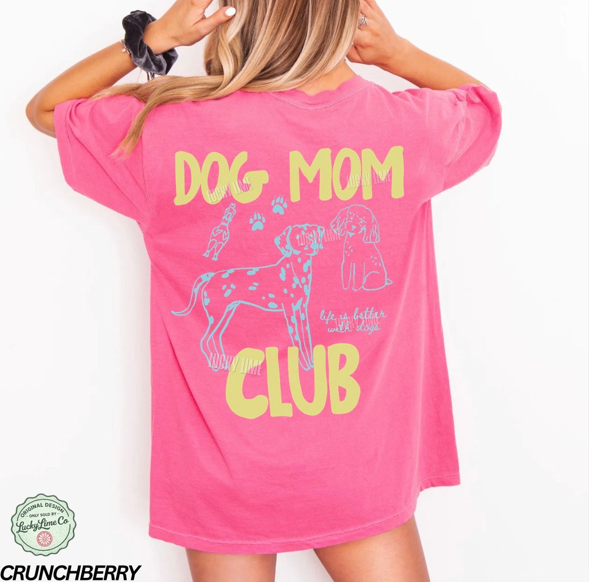 Pink t-shirt with 'Dog Mom Club' text and graphics on a white background