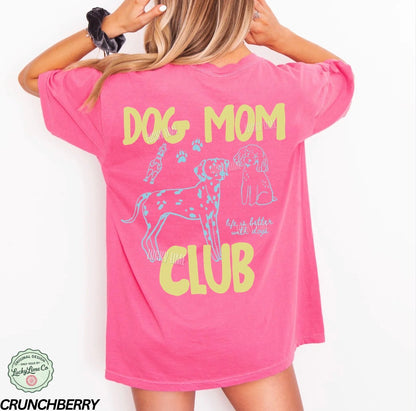 Pink t-shirt with 'Dog Mom Club' text and graphics on a white background