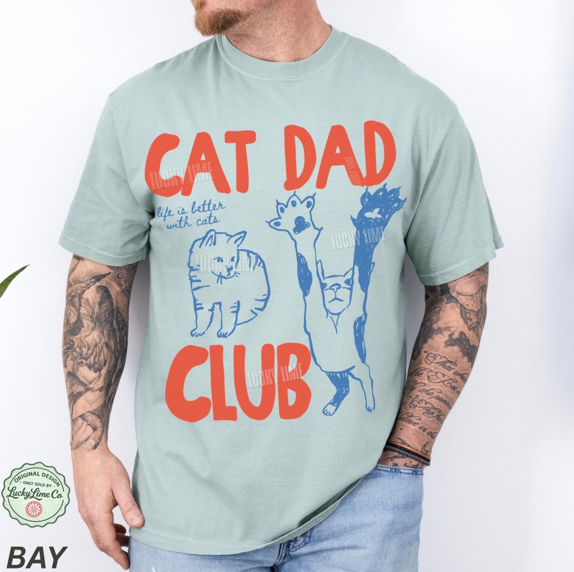 Person wearing a t-shirt with 'Cat Dad Club' text and cat illustrations on a white background