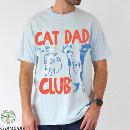 Light blue t-shirt with 'Cat Dad Club' text and cat illustrations on a white background