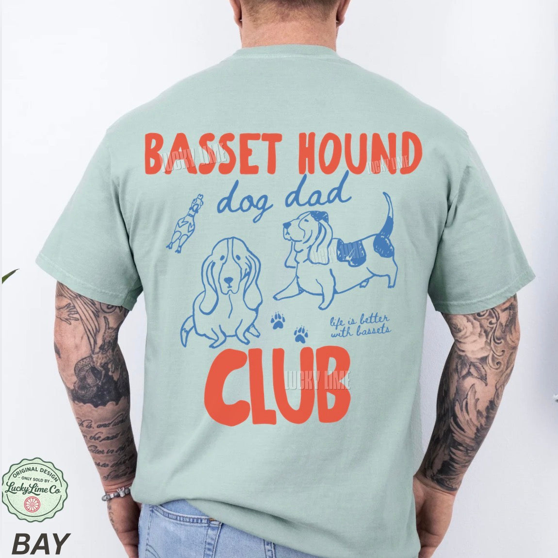 Light green t-shirt with 'Basset Hound Dog Dad Club' design on a white background