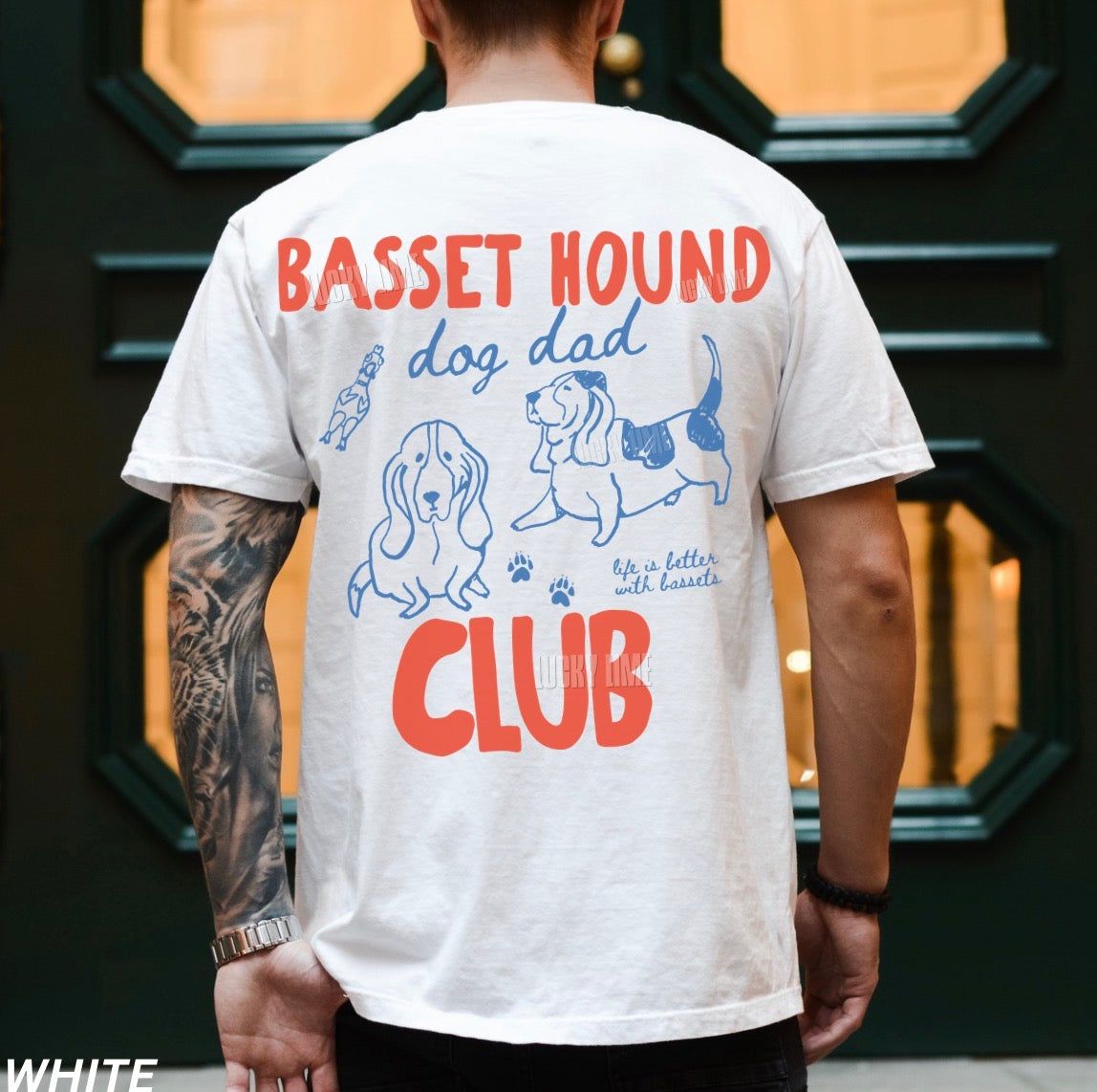 Person wearing a white t-shirt with 'Basset Hound Dog Dad Club' design on the back.