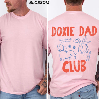 Pink t-shirt with 'Doxie Dad Club' design on a person wearing it.