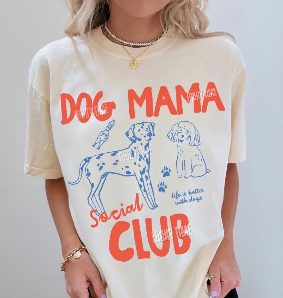 Person wearing a 'Dog Mama Social Club' t-shirt with dog illustrations.