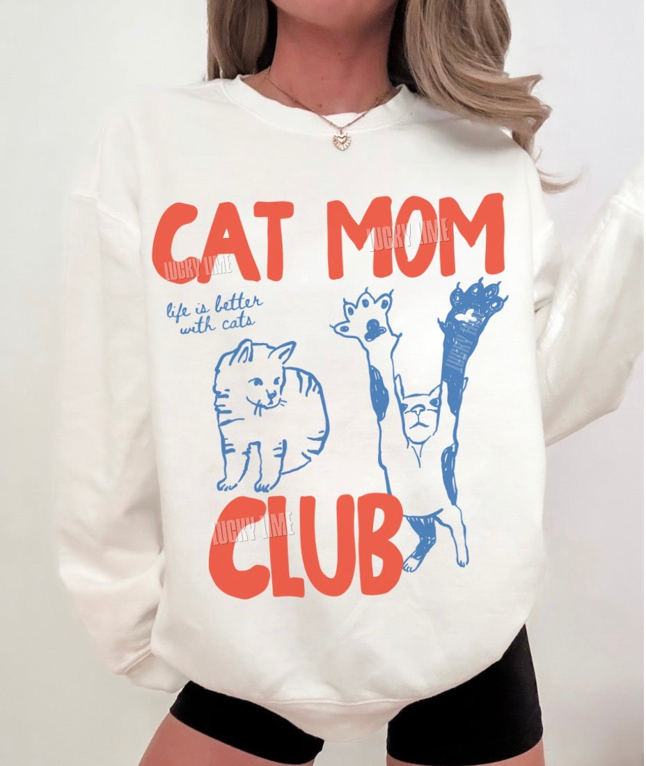 White sweatshirt with 'Cat Mom Club' text and cat illustrations on a white background