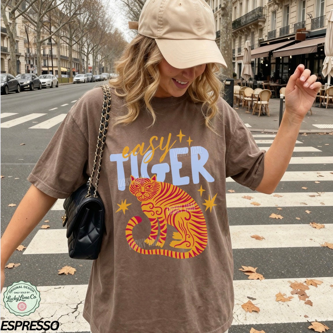 Woman wearing a brown 'easy tiger' t-shirt on a city street