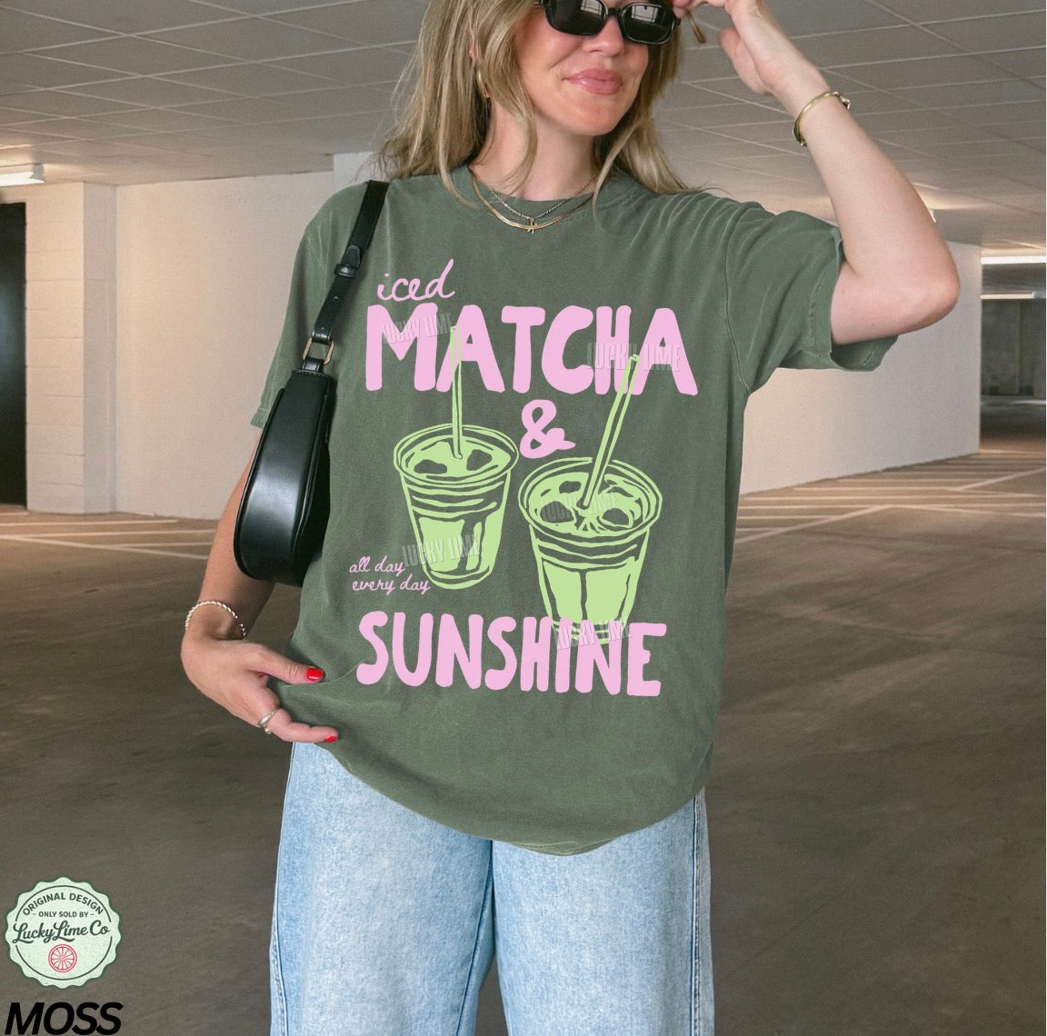 Person wearing a green t-shirt with 'iced matcha & sunshine' text in a casual setting.
