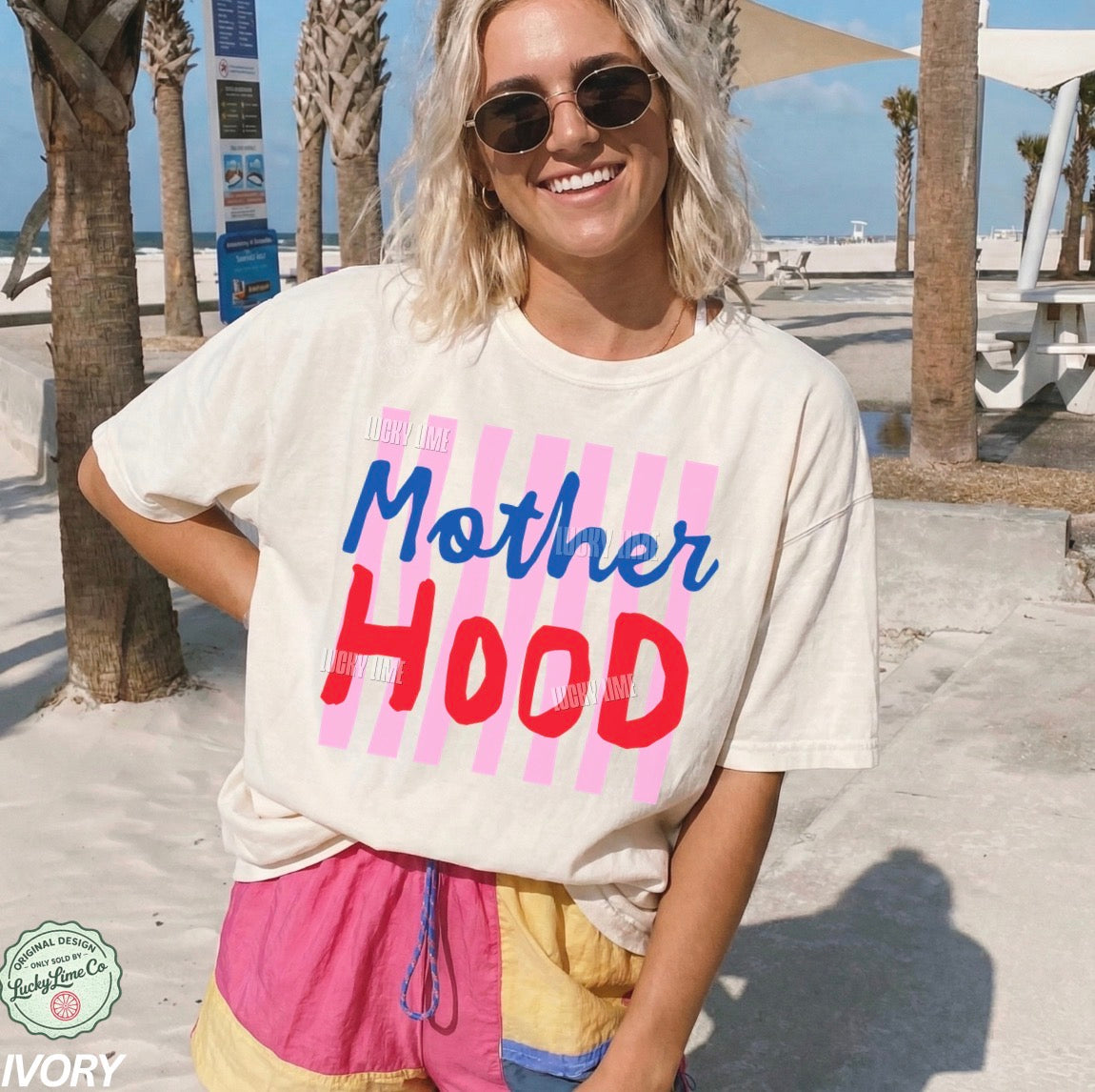 Woman wearing a t-shirt with 'Mother Hood' on a beach