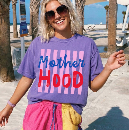 Person wearing a purple 'Mother Hood' t-shirt at a beach.