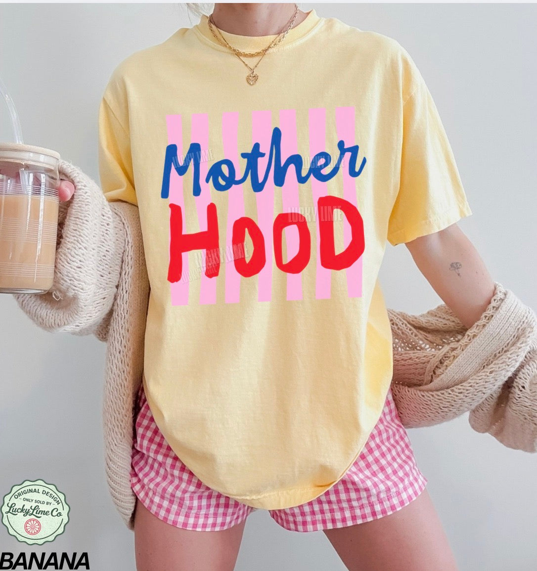 Person wearing a yellow t-shirt with 'Mother Hood' text, holding a drink, on a plain background.