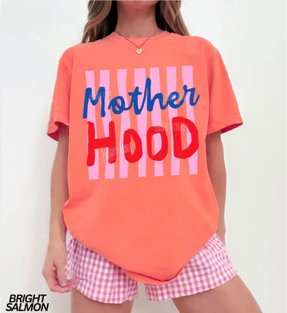 Person wearing a bright salmon-colored t-shirt with 'Mother Hood' text and pink checkered shorts on a white background.