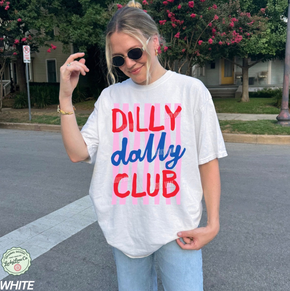 Person wearing a white t-shirt with colorful text in an urban setting