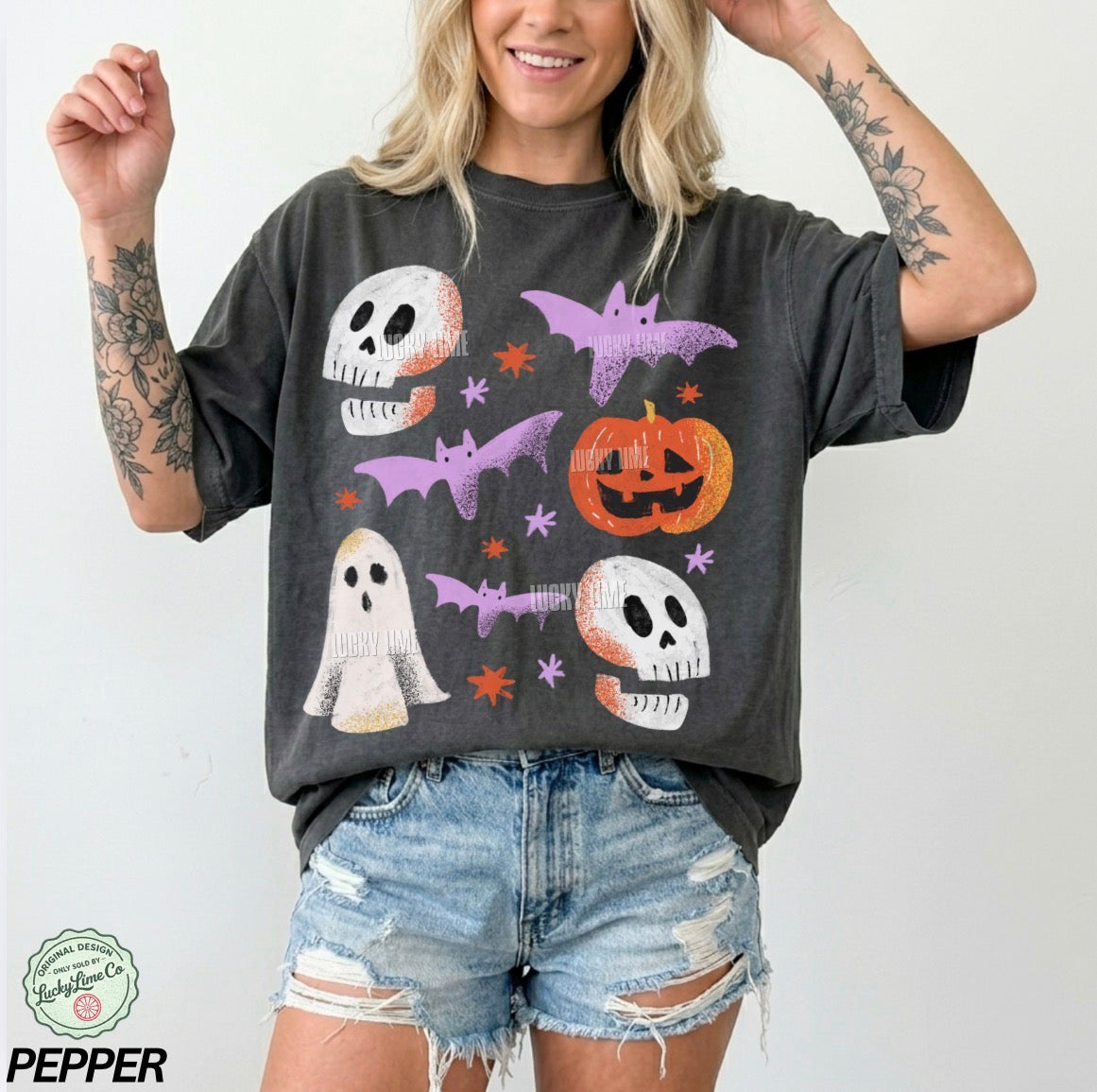 Person wearing a dark gray t-shirt with Halloween-themed graphics on a white background