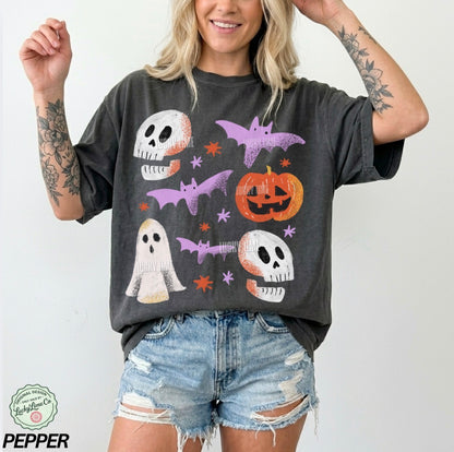 Person wearing a dark gray t-shirt with Halloween-themed graphics on a white background