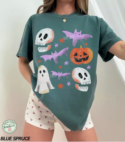 Person wearing a green t-shirt with Halloween-themed graphics and white shorts.