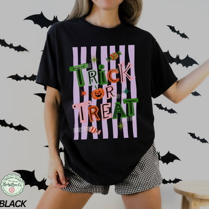 Person wearing a black 'Trick or Treat' Halloween shirt with bats in the background