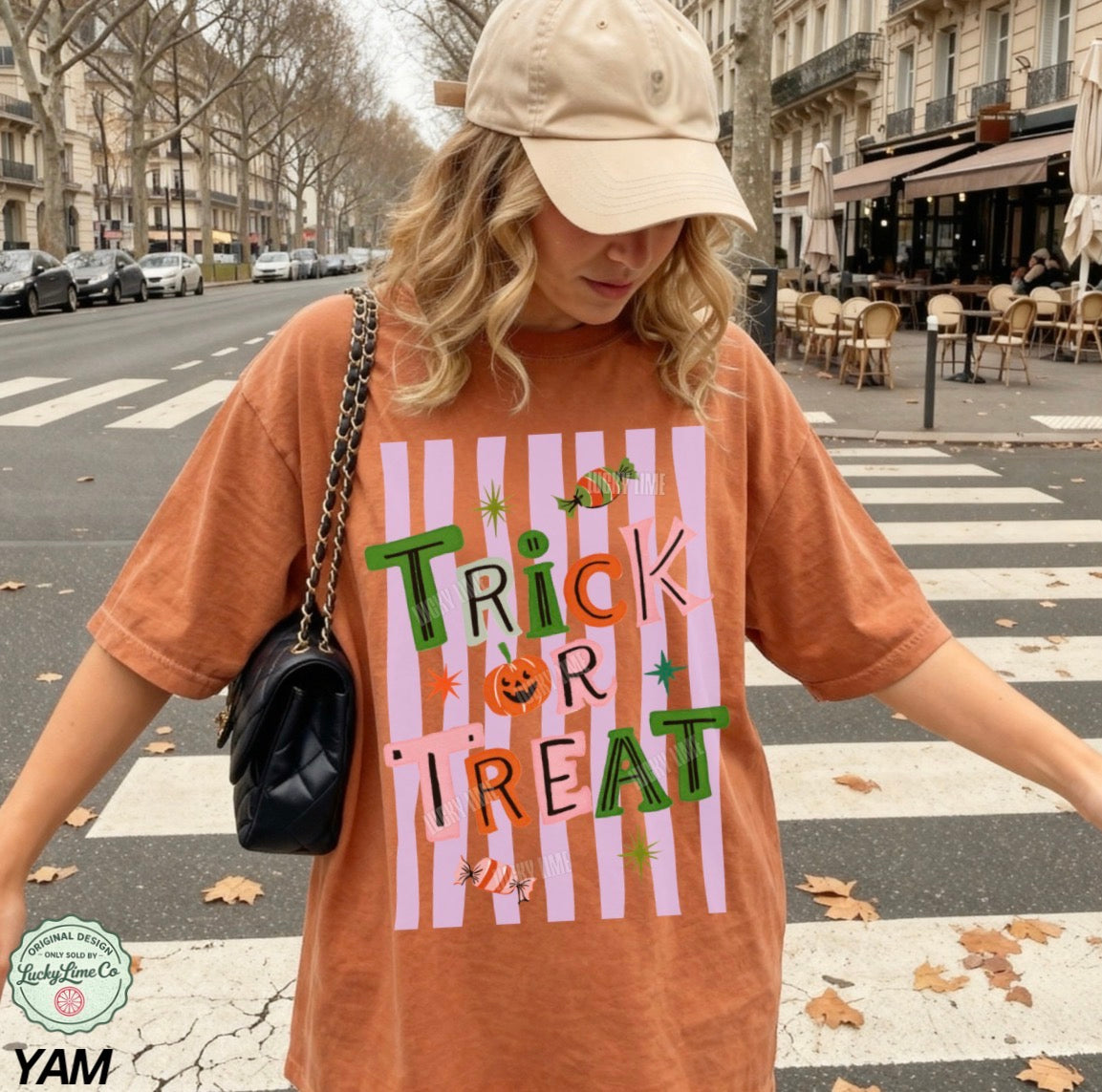Person wearing a 'Trick or Treat' shirt on a city street