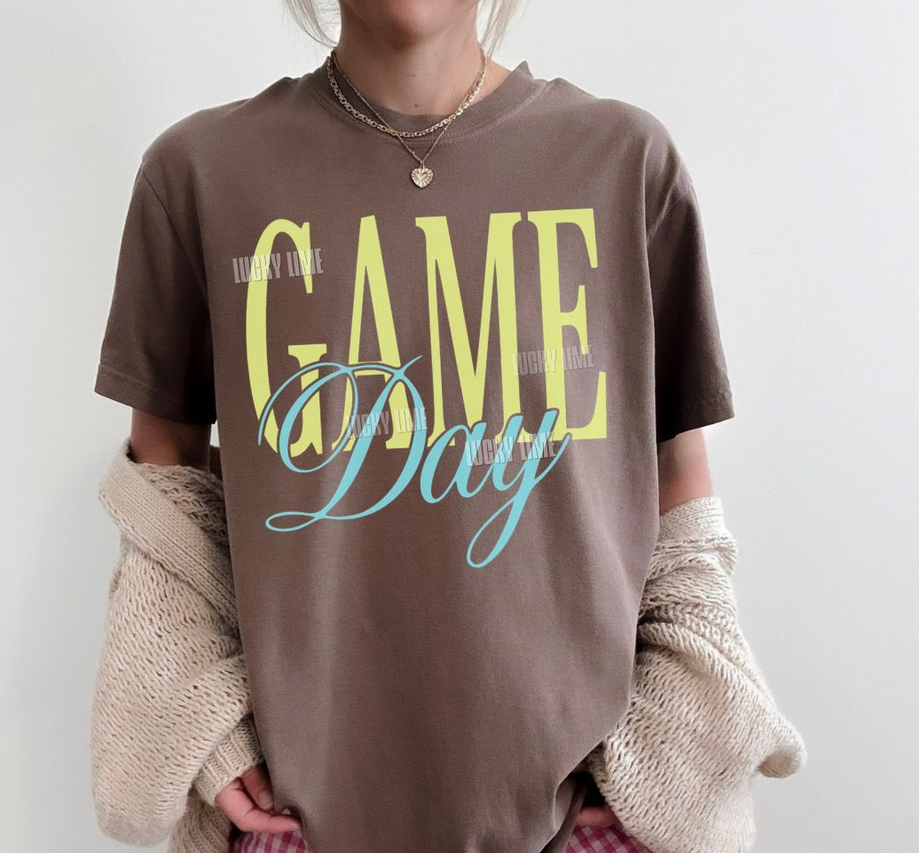 Woman wearing a brown tshirt with the words “Game Day”