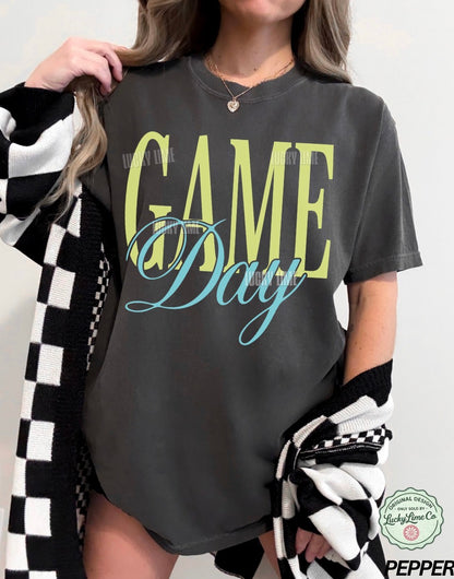 Woman wearing a dark grey tshirt with the words “Game Day” as a graphic