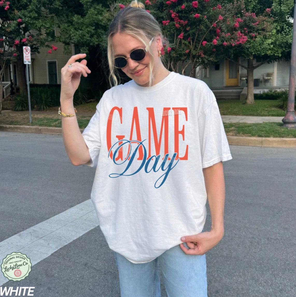 Person wearing a 'Game Day' t-shirt outdoors on a street.