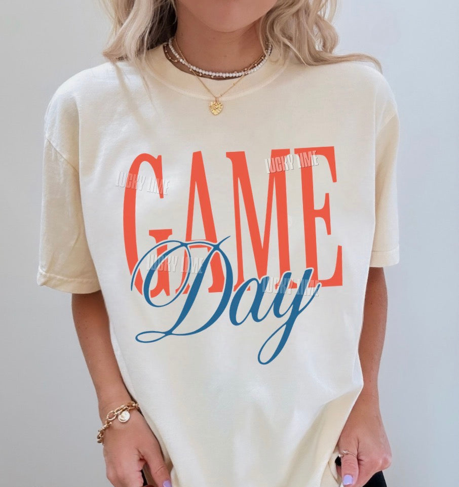 Person wearing a 'Game Day' t-shirt with colorful text on a plain background