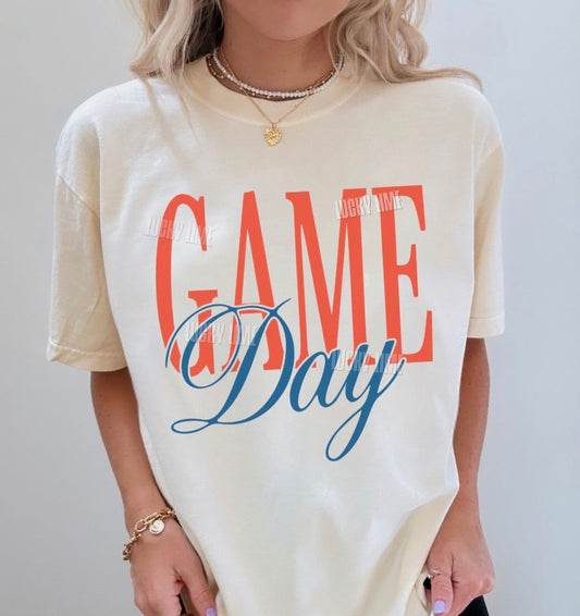 Person wearing a 'Game Day' t-shirt with colorful text on a plain background