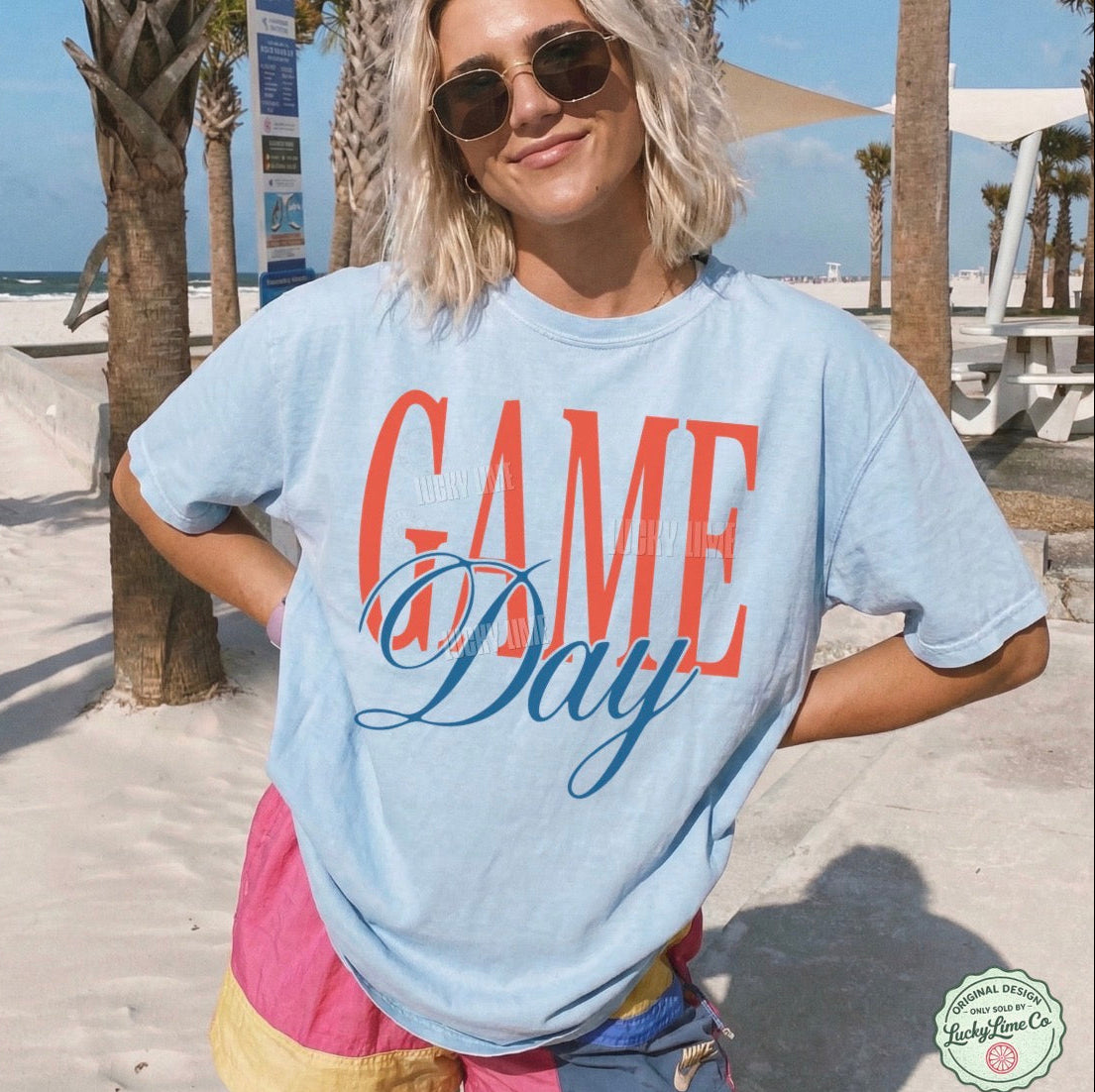 Person wearing a 'Game Day' t-shirt on a beach