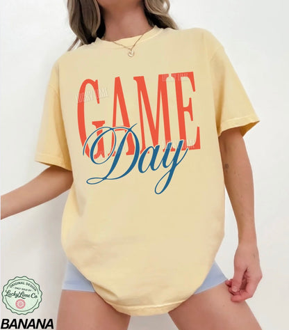 Yellow t-shirt with 'GAME Day' text worn by a person on a white background