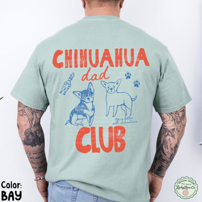 Person wearing a light green t-shirt with 'Chihuahua Dad Club' text and graphics on the back.