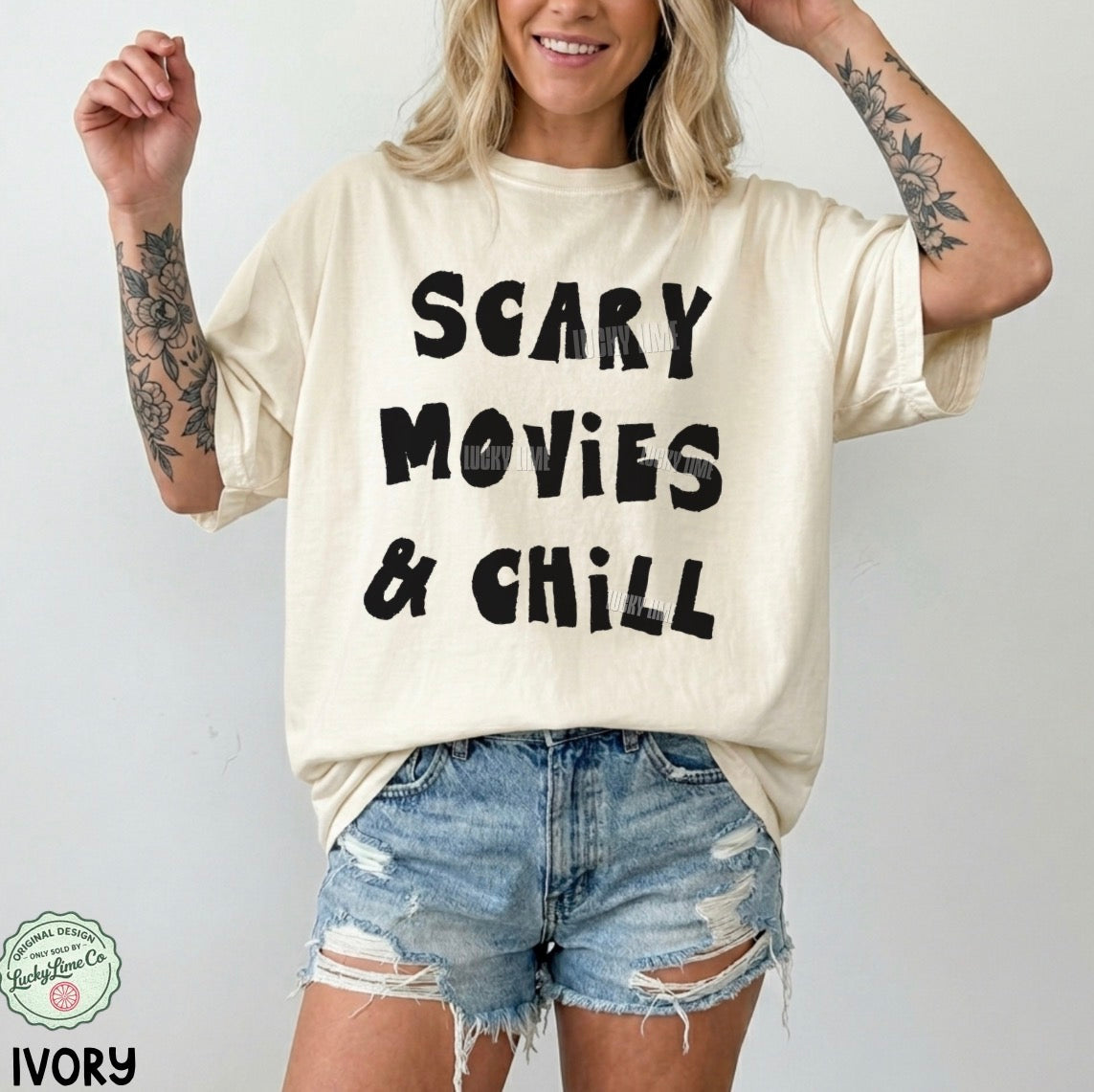 Person wearing a 'Scary Movies & Chill' t-shirt with denim shorts on a plain background