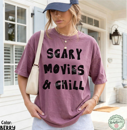 Person wearing a purple t-shirt with 'SCARY MOVIES & CHILL' text, standing outside a house.