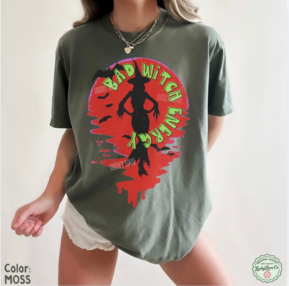 Person wearing a green t-shirt with a graphic design and text on a plain background