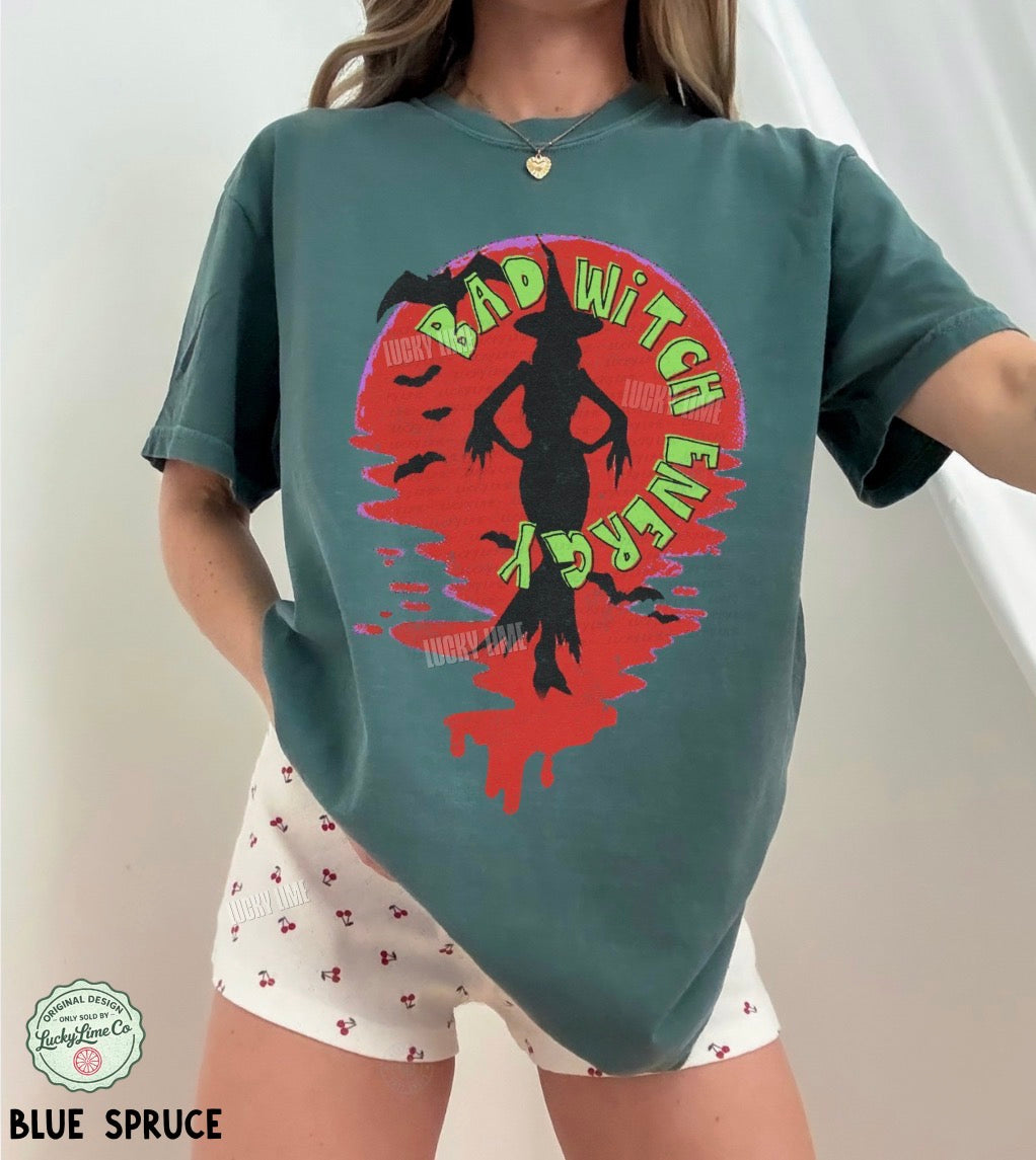 Person wearing a green t-shirt with a colorful graphic design and text.