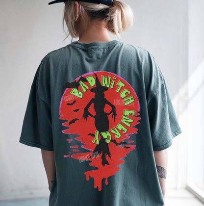 Person wearing a t-shirt with a graphic design and text on the back.
