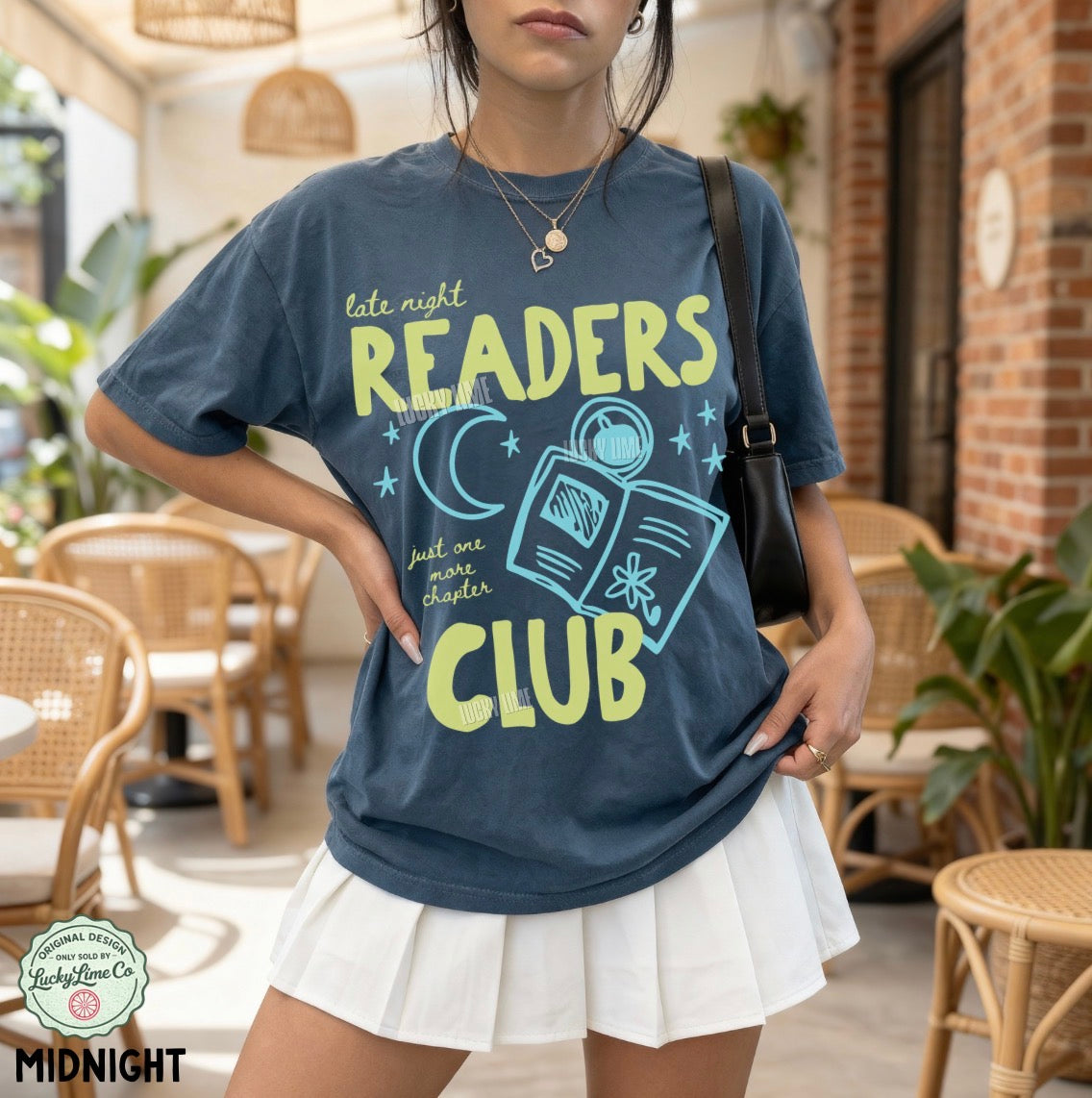 Person wearing a 'Late Night Readers Club' t-shirt in a casual setting