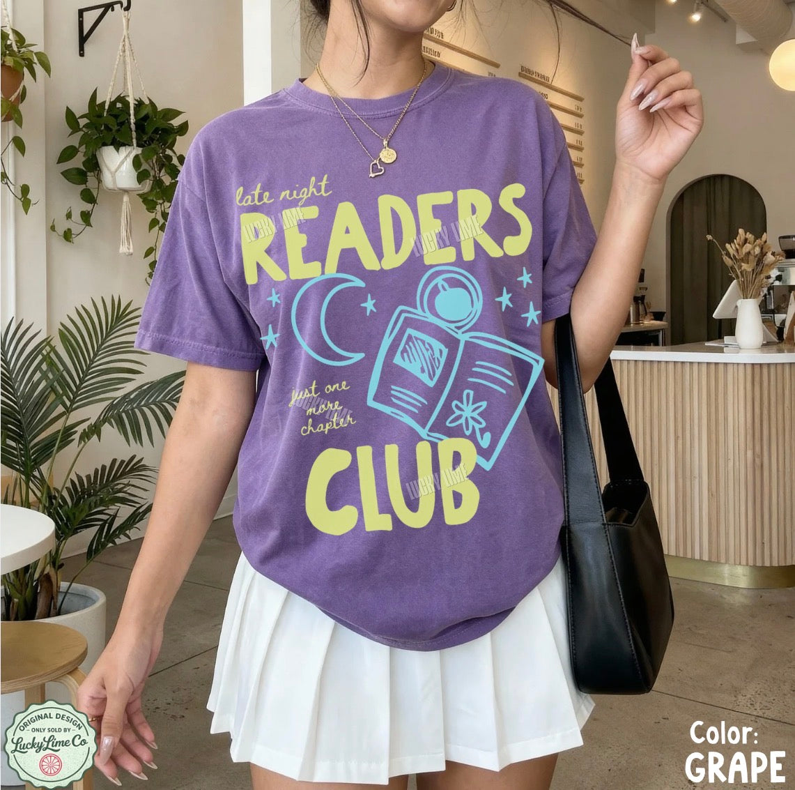 Person wearing a purple 'Readers Club' t-shirt in an indoor setting