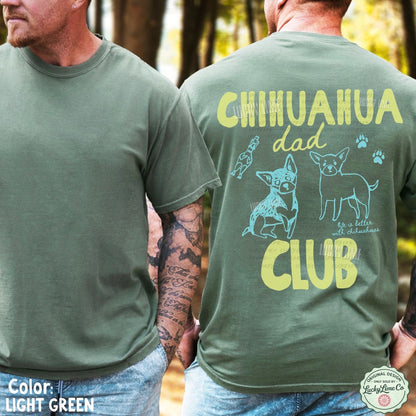 Two men wearing light green t-shirts, one plain and one with 'Chihuahua dad club' design.