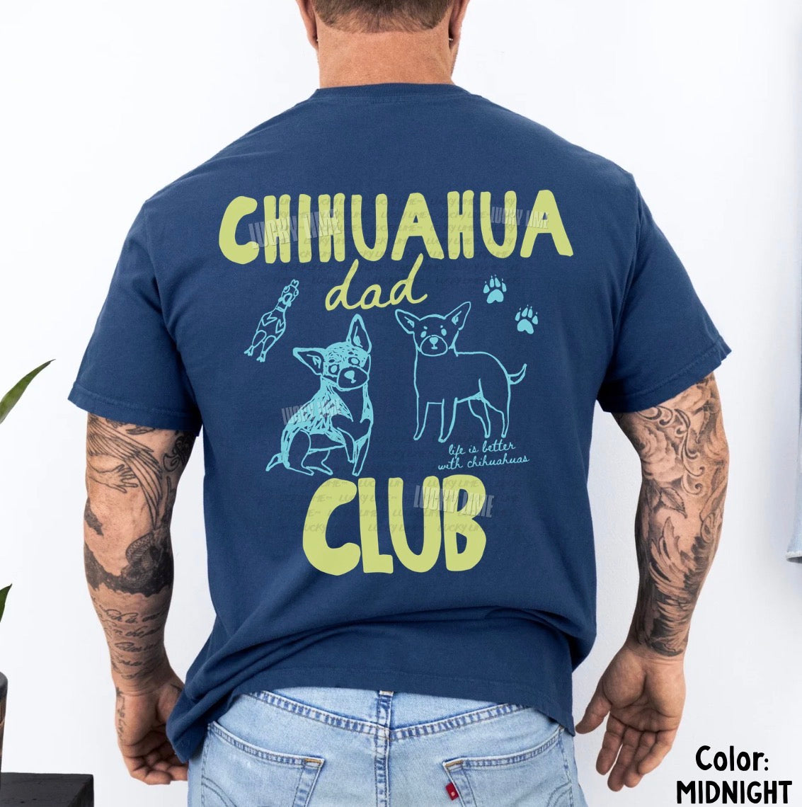 Person wearing a navy blue t-shirt with 'Chihuahua Dad Club' text and graphics on the back.