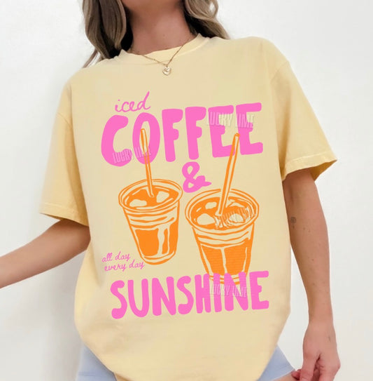 Person wearing a yellow t-shirt with 'iced coffee & sunshine' text and graphics.