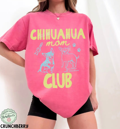 Person wearing a pink t-shirt with 'Chihuahua mom club' text and graphics on a white background