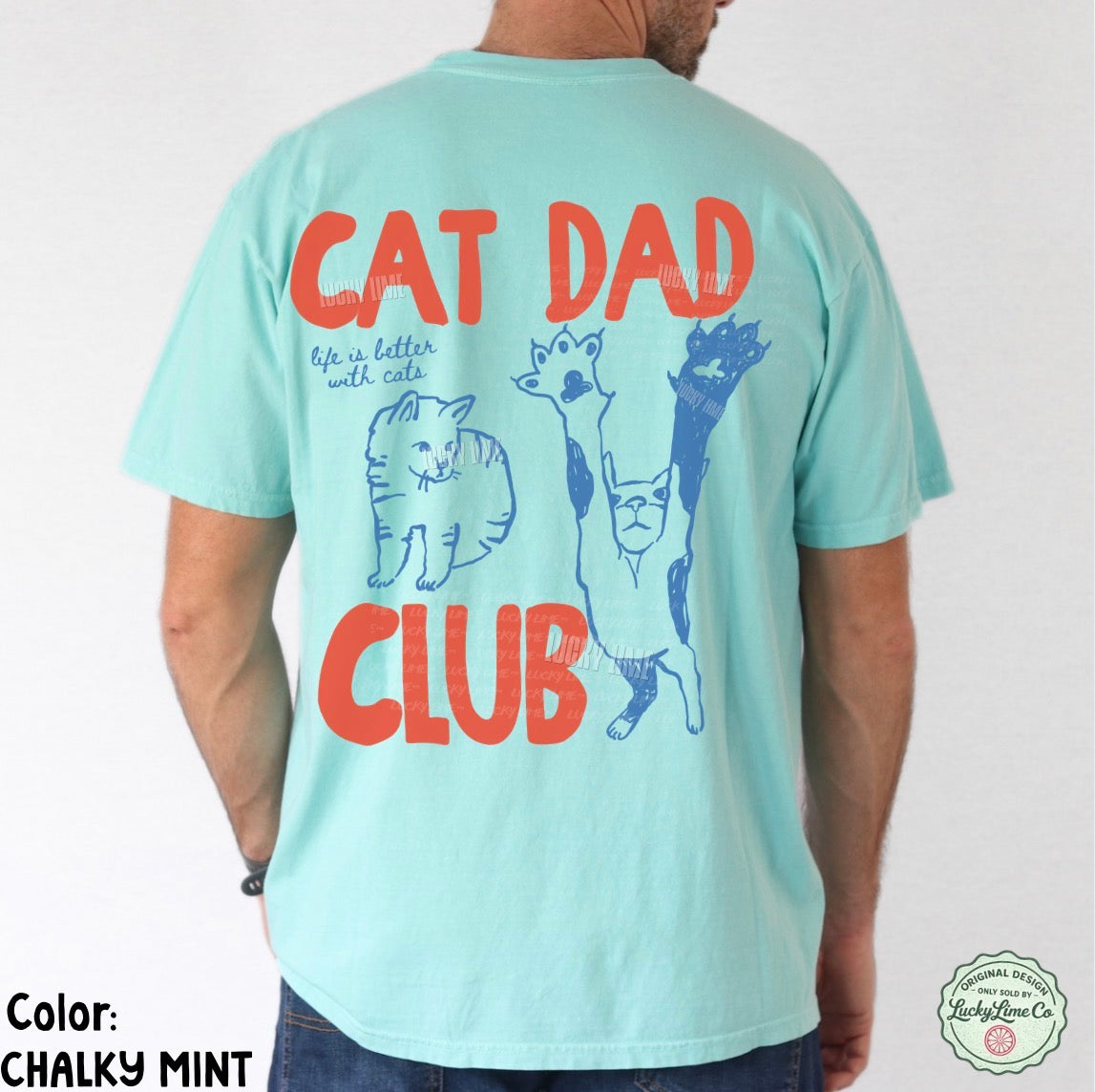 Person wearing a light blue t-shirt with 'Cat Dad Club' text and cat illustrations on the back.