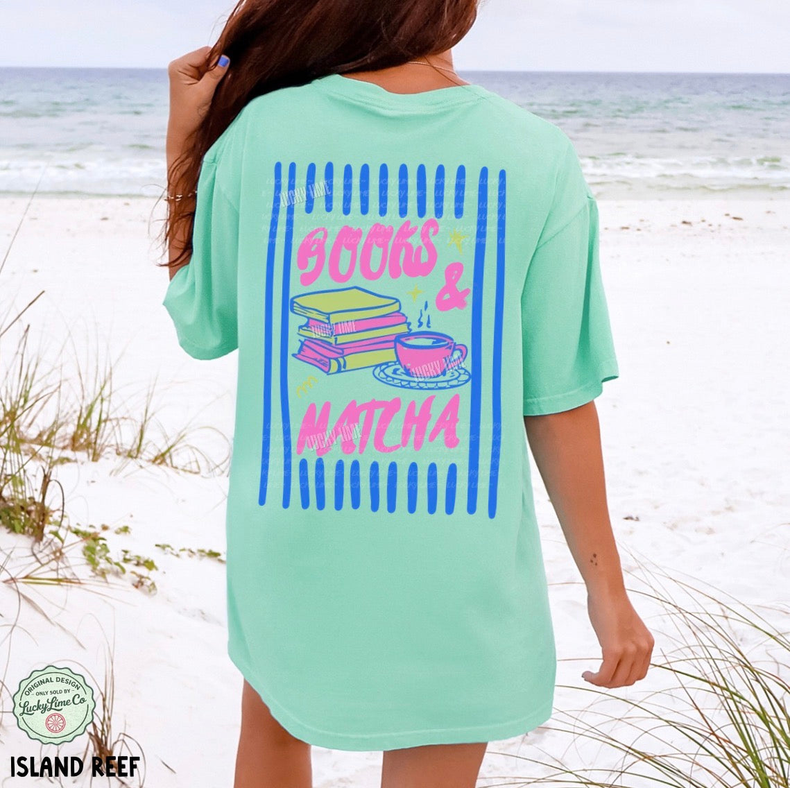 Person wearing a light green t-shirt with 'Books & Matcha' design on a beach.