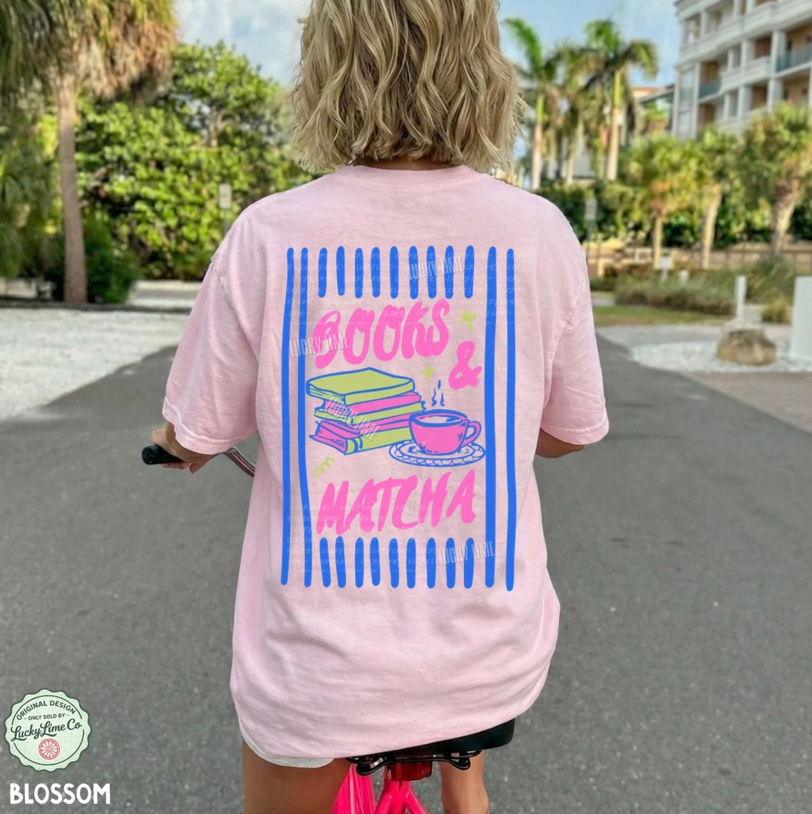 Person wearing a pink t-shirt with 'Books & Matcha' design outdoors.