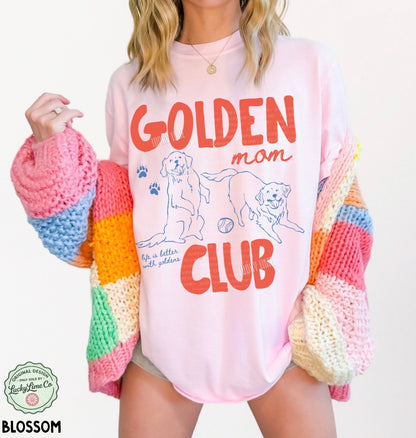 Person wearing a colorful sweater with 'Golden Mom Club' text and graphics.